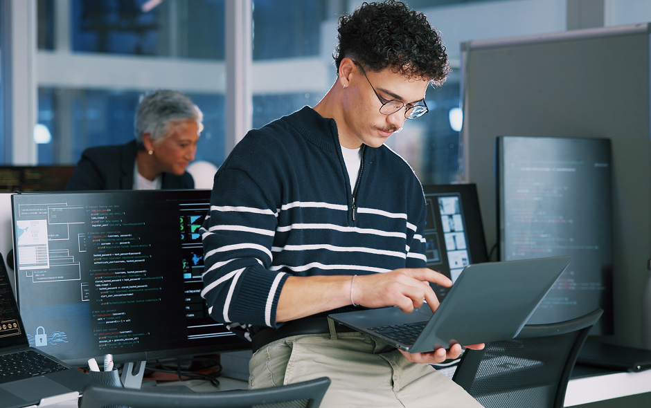 developer working on code on laptop in office