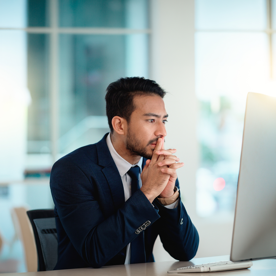 person analysing data on computer with focused expression