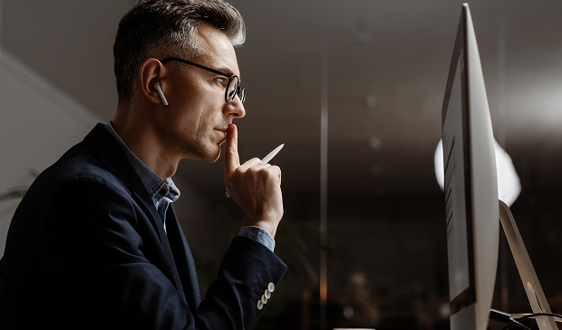 specialist focused on resolving issue while working at computer